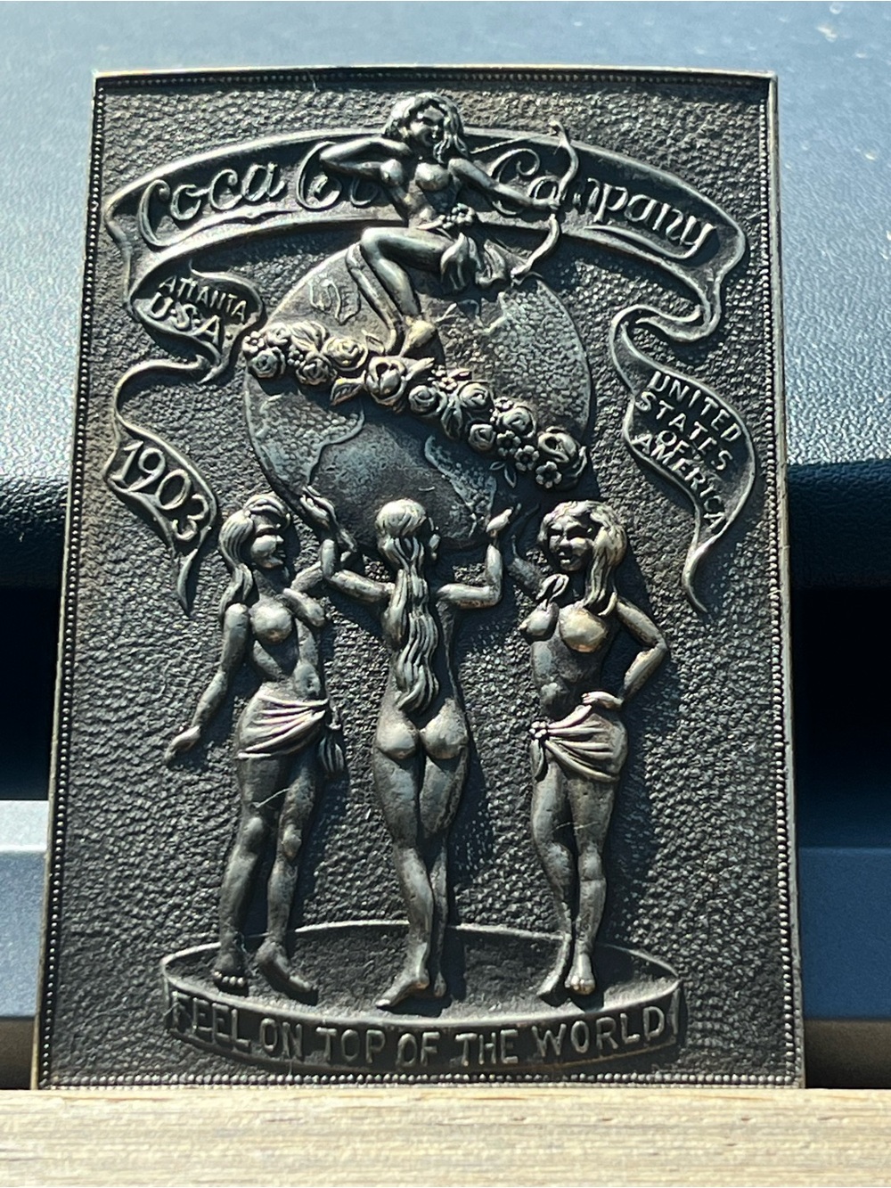 Coca-Cola Embossed Metal Plaque in Dark Metallic Black